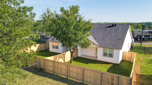 a view of a house with wooden fence