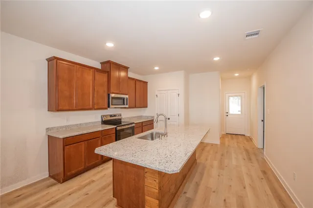 a kitchen with a sink a counter top space and appliances
