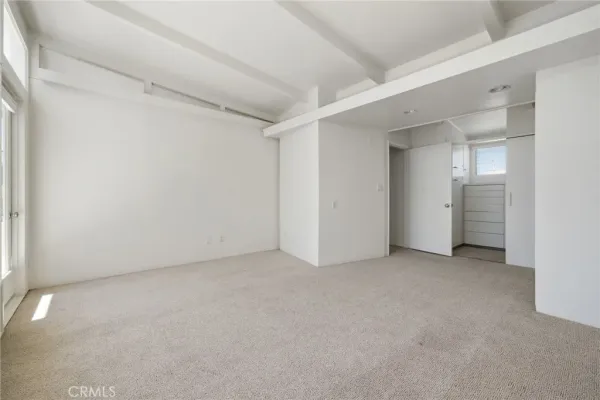 an empty room with closet area