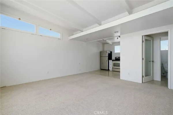 an empty room with closet and a window