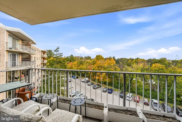 a view of a balcony with couches and wooden floor