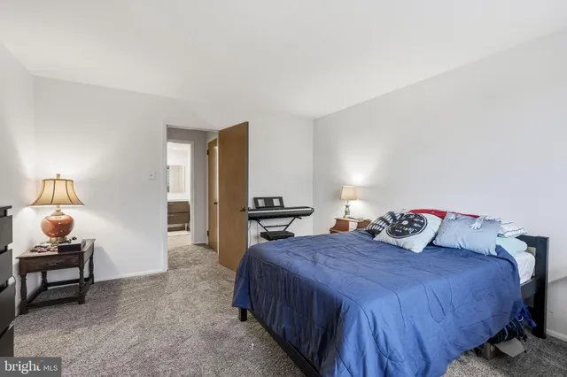 a bedroom with a bed and a lamp on table