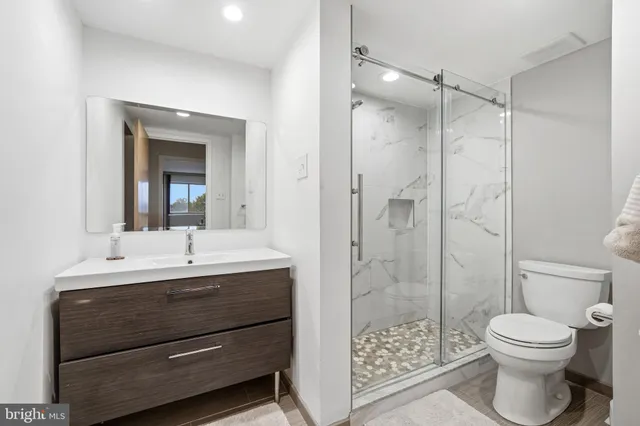a bathroom with a double vanity sink toilet and shower