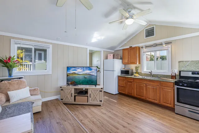 a kitchen with sink cabinets and wooden floor