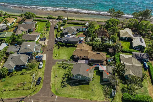an aerial view of a houses with yard