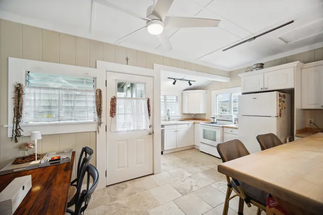 a kitchen with white cabinets and stainless steel appliances