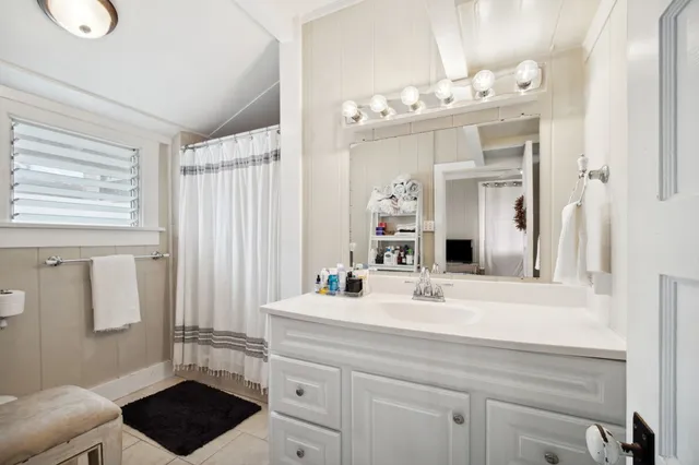 a bathroom with a sink a vanity and a mirror