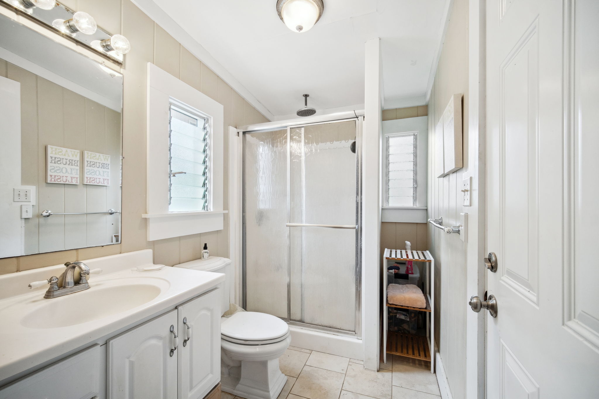 4463 Makaha Road Kapaa, HI 96746 - Photo 9 of 23 a bathroom with a sink toilet and shower