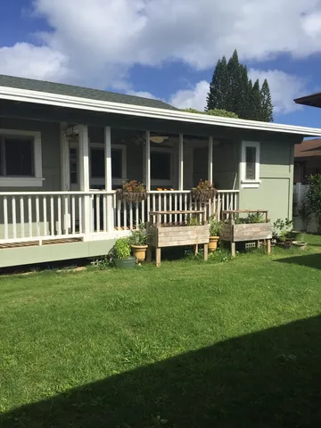 a view of a house with a yard and deck