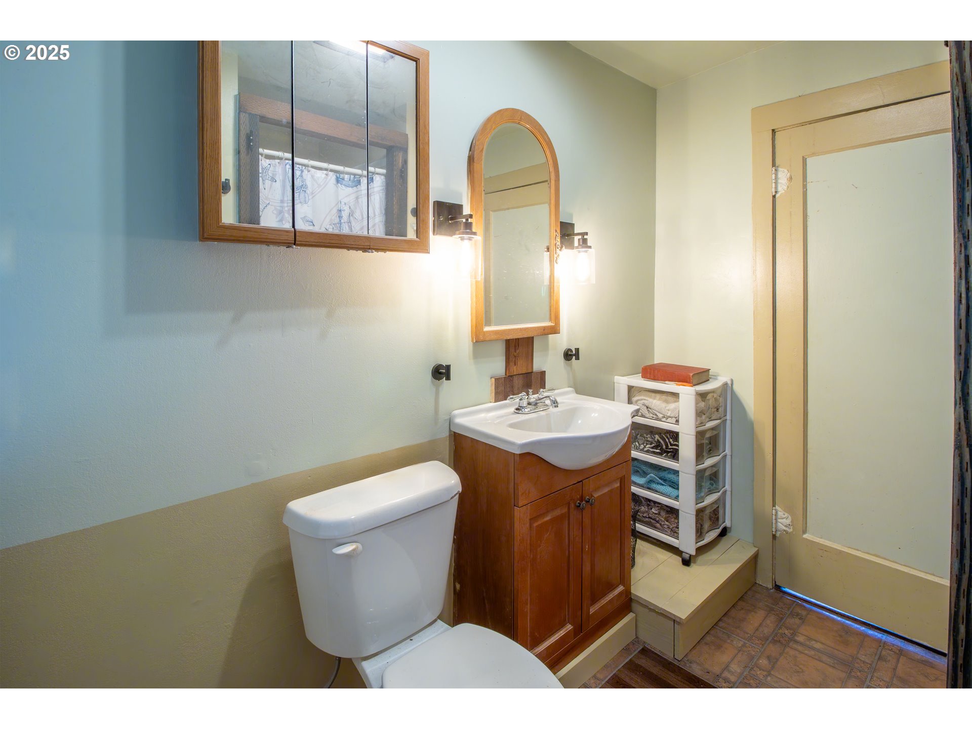 655 6th Street Myrtle Point, OR 97458 - Photo 11 of 31 a bathroom with a toilet sink and mirror