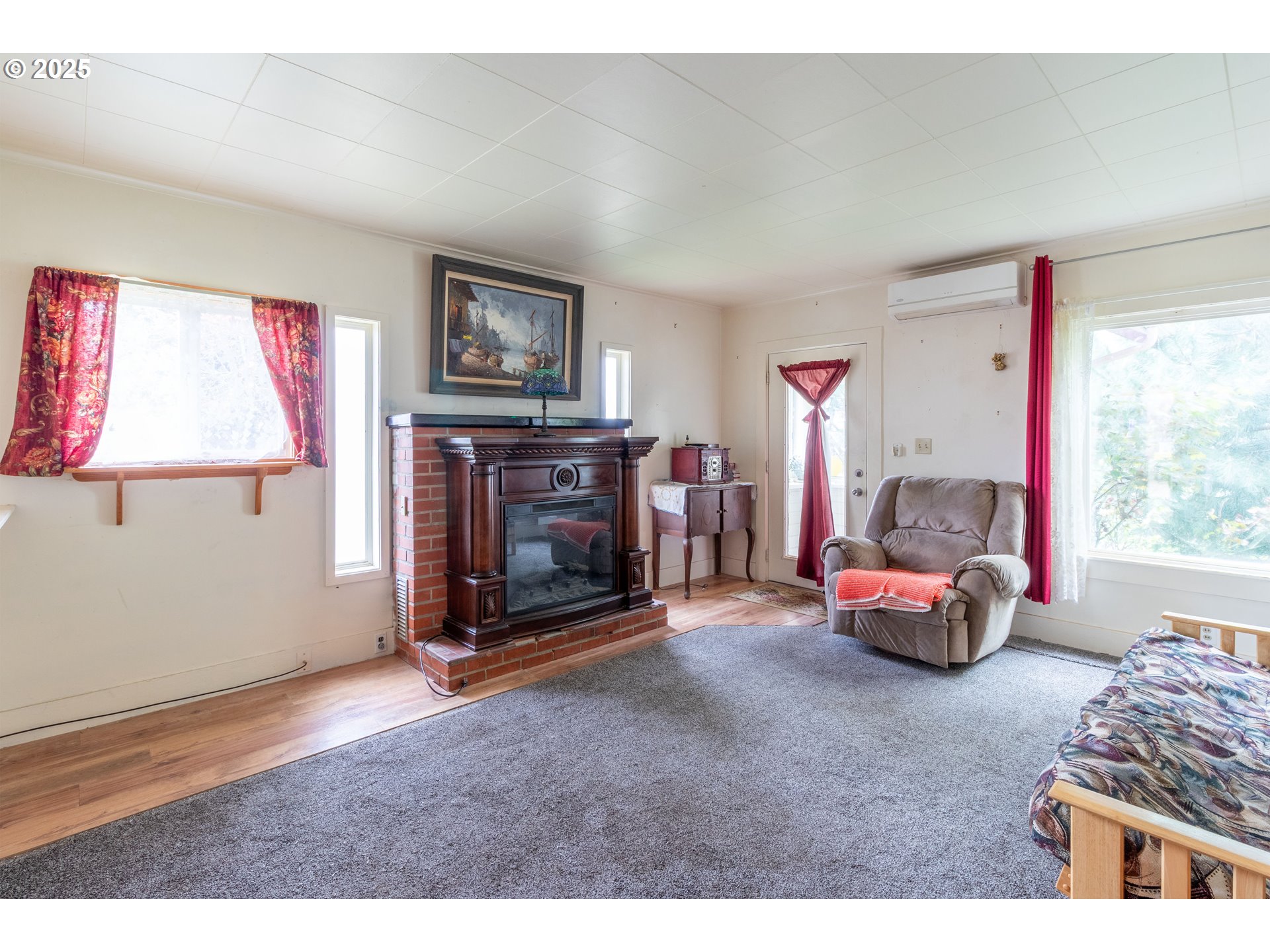 655 6th Street Myrtle Point, OR 97458 - Photo 6 of 31 a bedroom with furniture and a fireplace