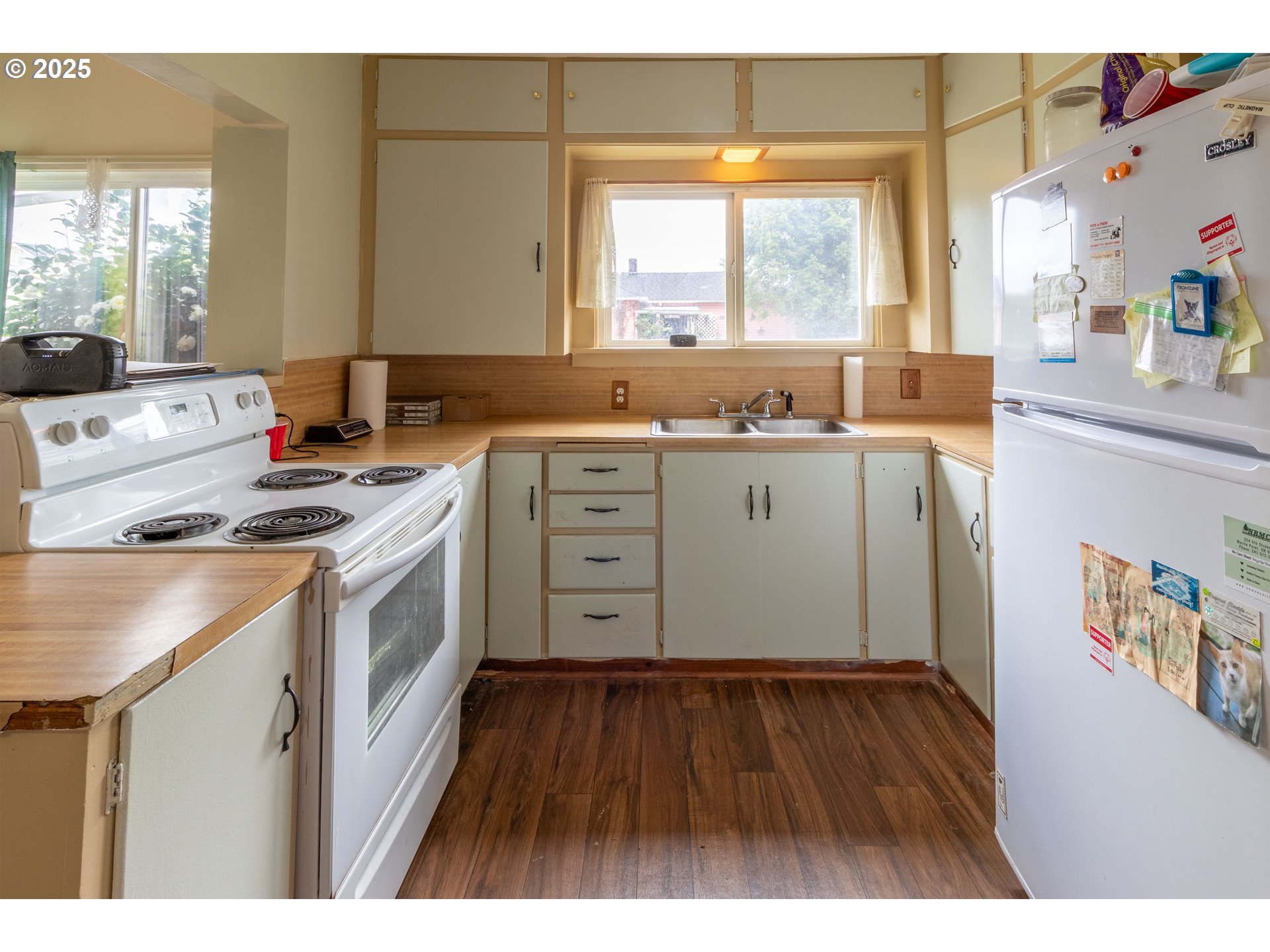 655 6th Street Myrtle Point, OR 97458 - Photo 8 of 31 a kitchen with a stove a sink a window and wooden floor