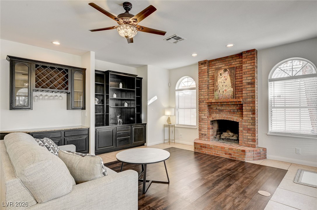 2955 El Camino Road Las Vegas, NV 89146 - Photo 23 of 99 Living room featuring a fireplace, recessed lighting, a ceiling fan, and light wood-type flooring
