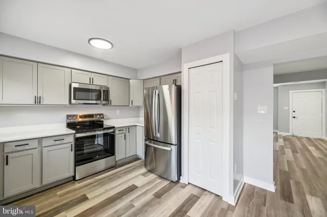 a kitchen with a refrigerator stove and microwave