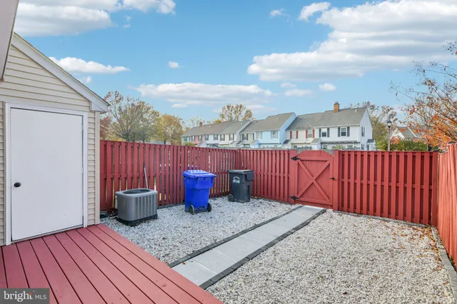 a view of a roof deck with table and chairs