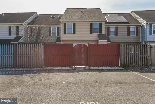 a front view of a house with a fence