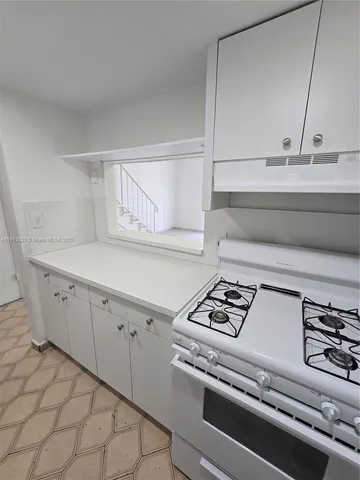 a view of an empty room and a window