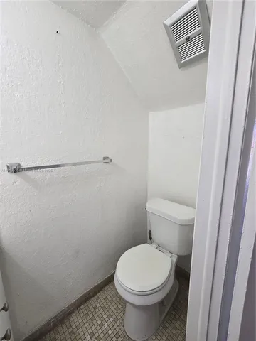 a view of a livingroom with an empty space and a window