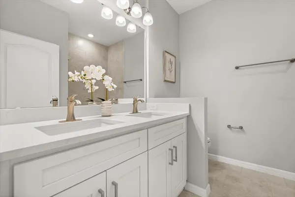 a bathroom with a sink vanity and a mirror