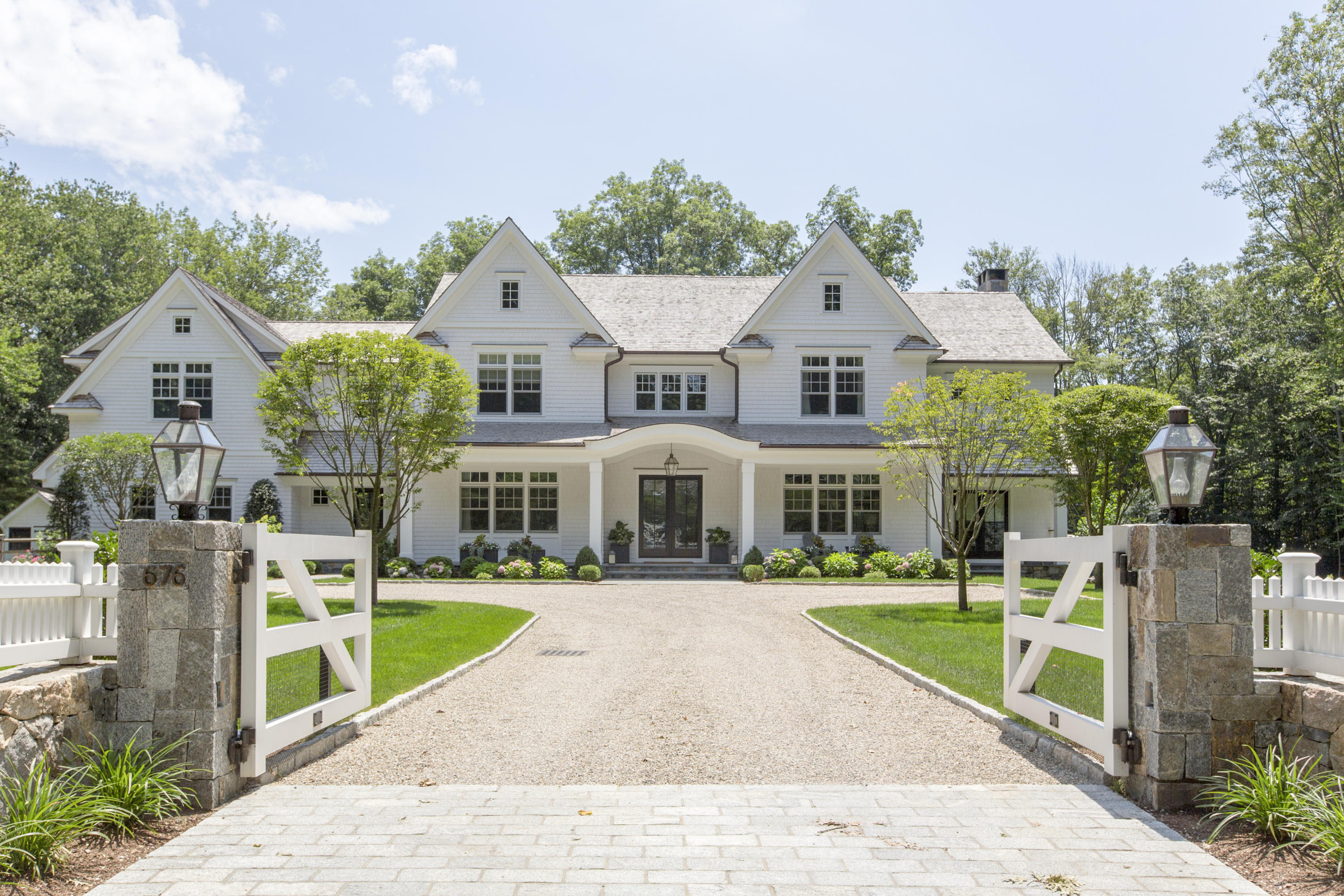 676 Hollow Tree Ridge Road Darien, CT 06820 - Photo 1 of 50 a front view of a house with a yard