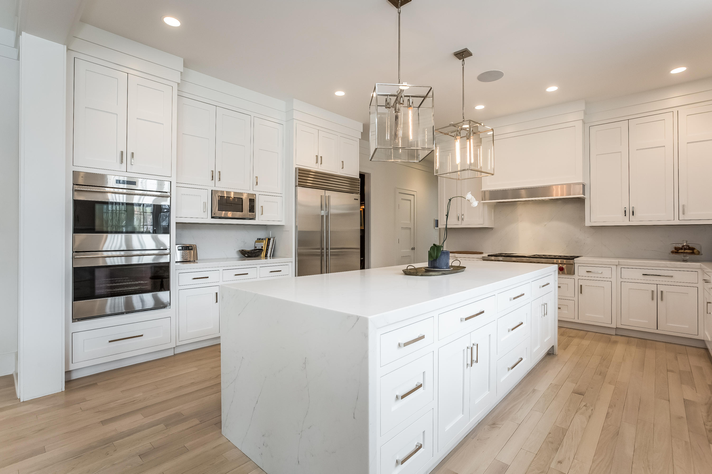 676 Hollow Tree Ridge Road Darien, CT 06820 - Photo 12 of 50 a kitchen with kitchen island granite countertop a white cabinets and refrigerator