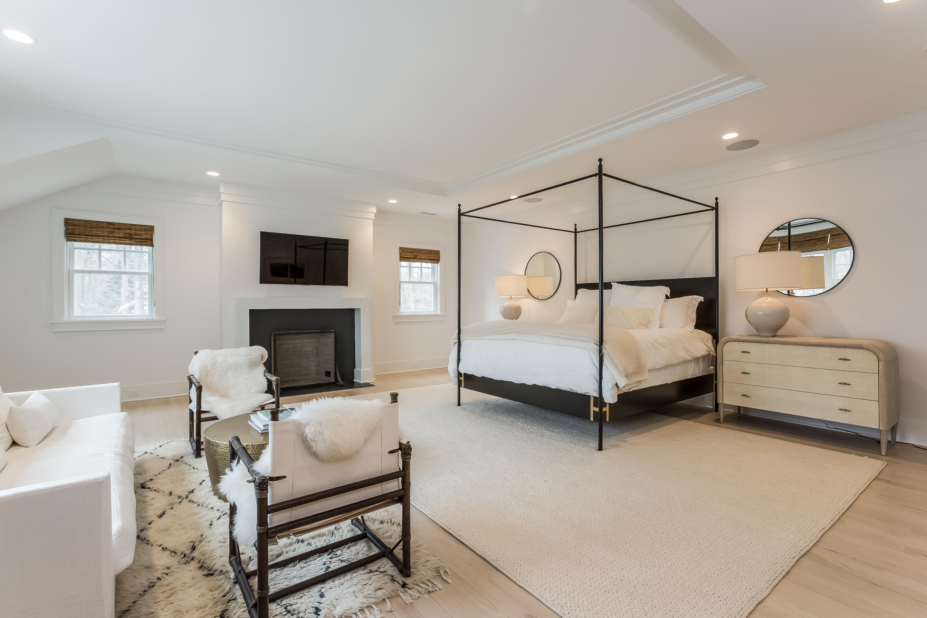 676 Hollow Tree Ridge Road Darien, CT 06820 - Photo 24 of 50 a bedroom with furniture and a fireplace