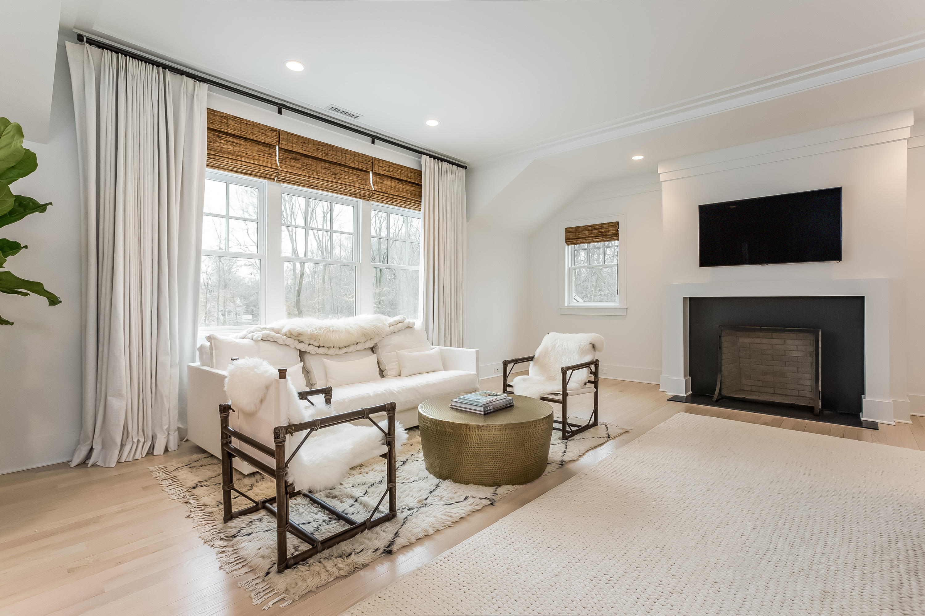 676 Hollow Tree Ridge Road Darien, CT 06820 - Photo 25 of 50 a living room with furniture a flat screen tv and a fireplace