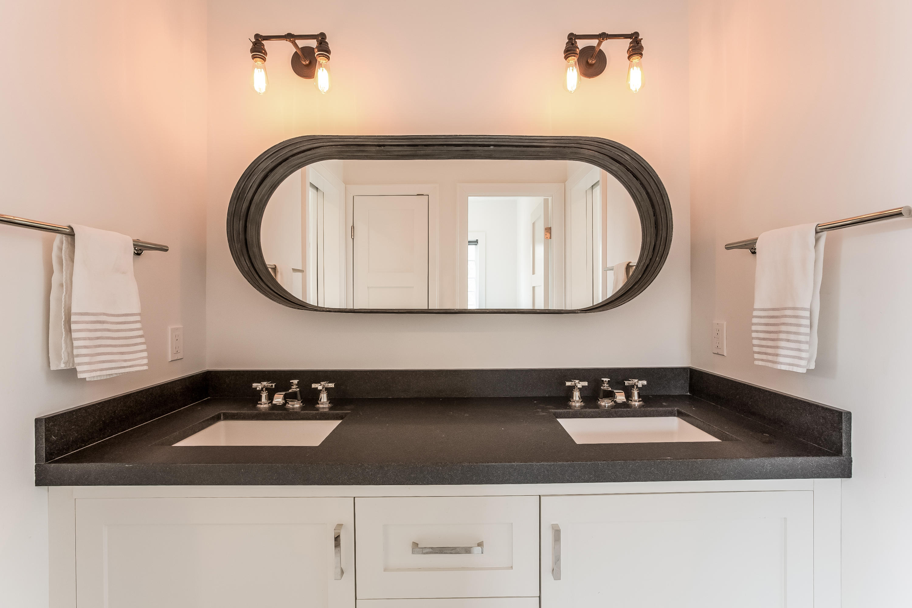 676 Hollow Tree Ridge Road Darien, CT 06820 - Photo 29 of 50 a bathroom with a sink and a mirror