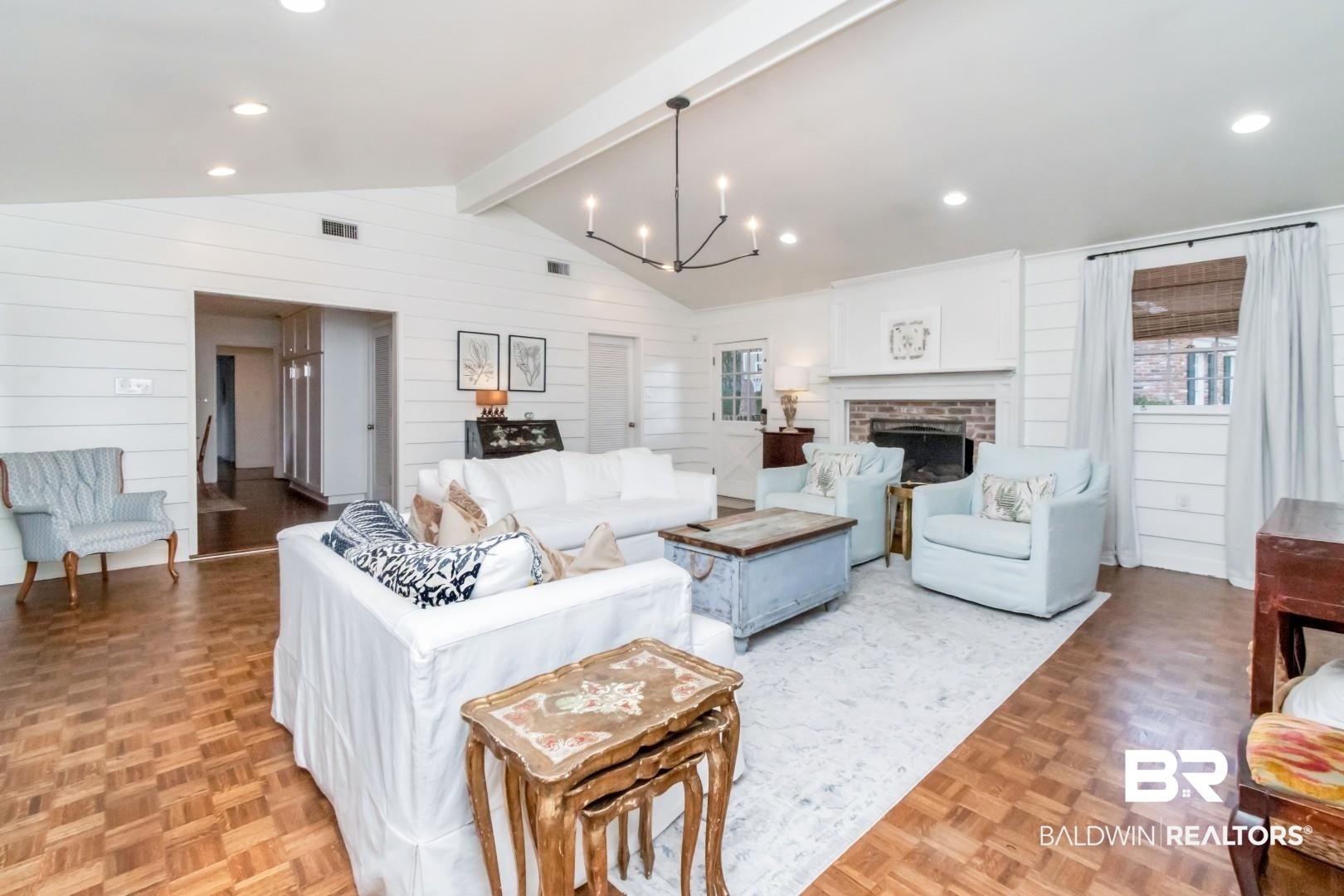 154 Fenwick Road Mobile, AL 36608 - Photo 4 of 48 Living room with parquet floors, suspended lighting, wooden walls, beam ceiling, and a fireplace