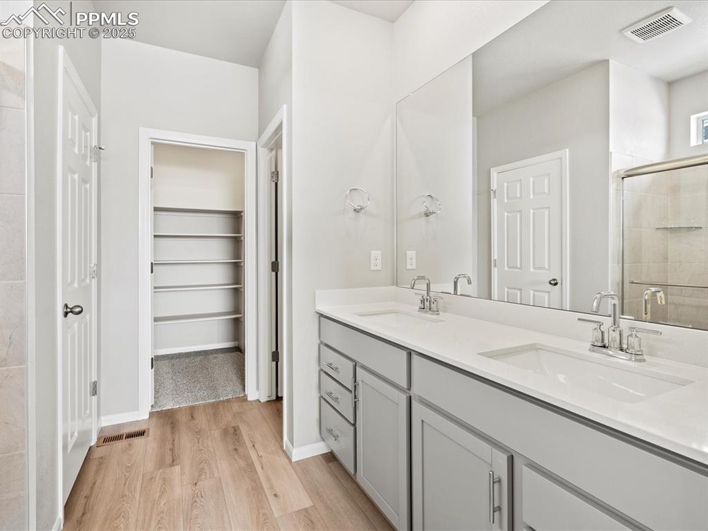 10434 Devoncove Drive Peyton, CO 80831 - Photo 18 of 24 a bathroom with a sink and a mirror