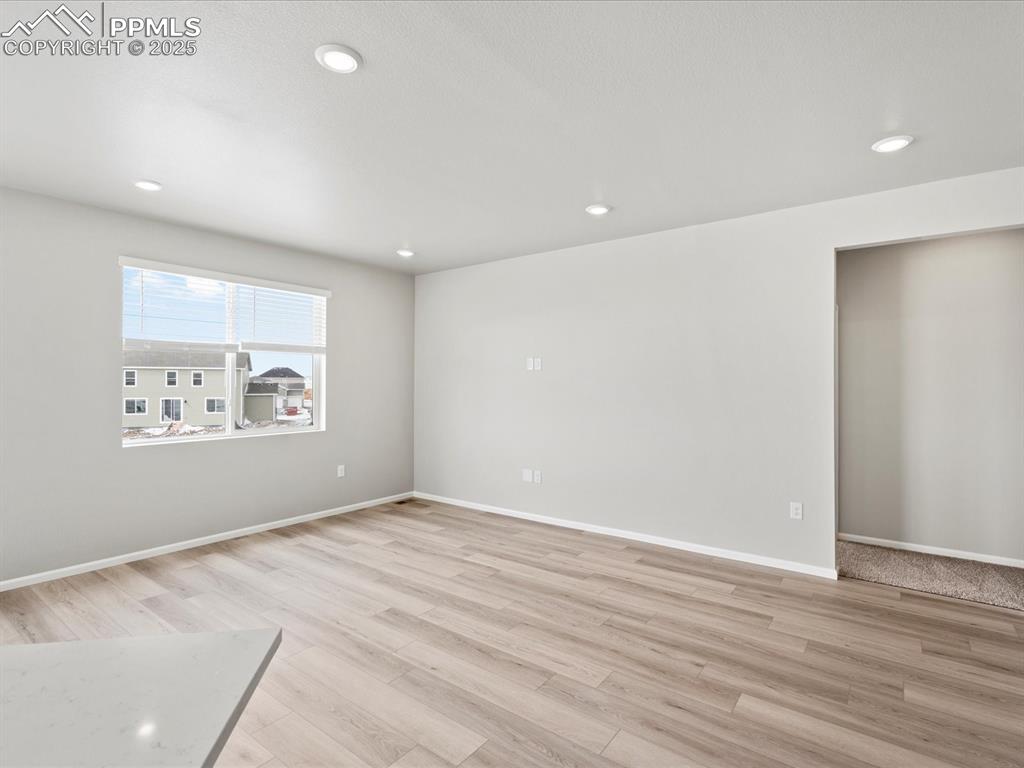 10434 Devoncove Drive Peyton, CO 80831 - Photo 9 of 24 wooden floor in an empty room with a window