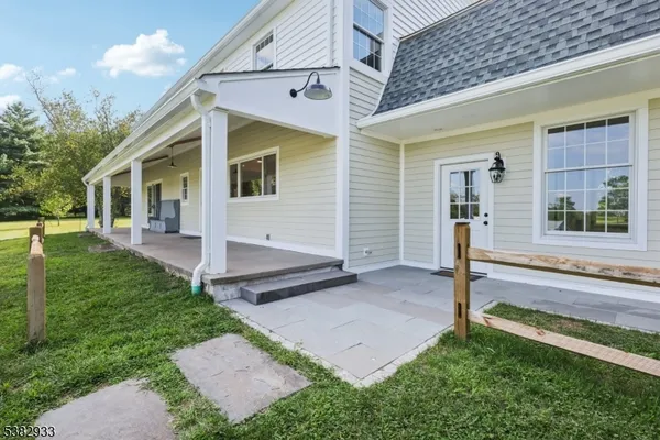 a view of hallway with wooden floor and window