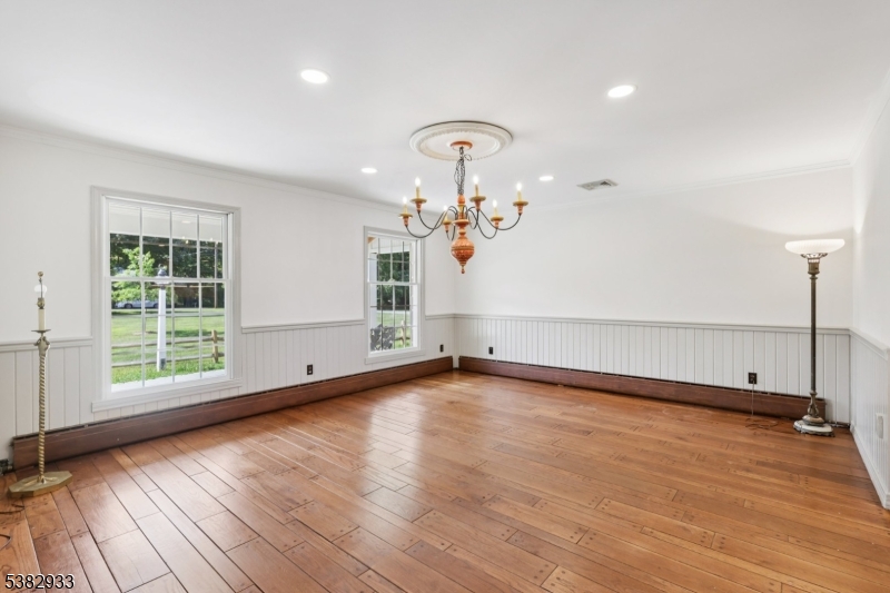 60 Perryville Road Pittstown, NJ 08867 - Photo 21 of 50 an empty room with wooden floor chandelier and windows