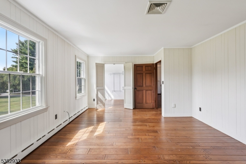 60 Perryville Road Pittstown, NJ 08867 - Photo 28 of 50 a view of an empty room with wooden floor and a window