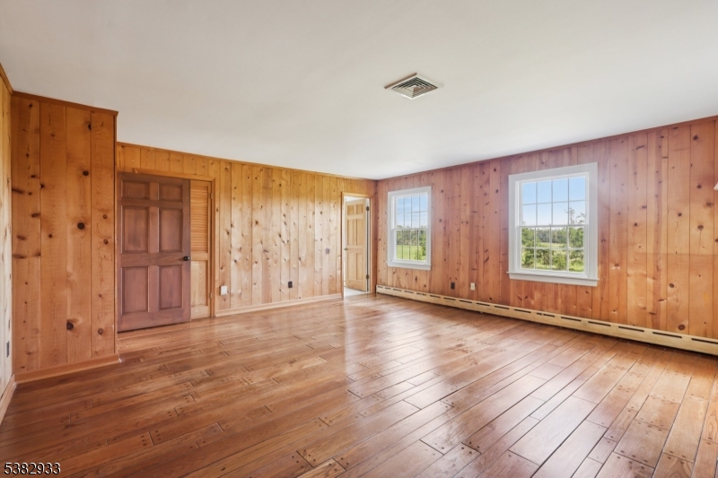 60 Perryville Road Pittstown, NJ 08867 - Photo 30 of 50 a view of an empty room with wooden floor and a window