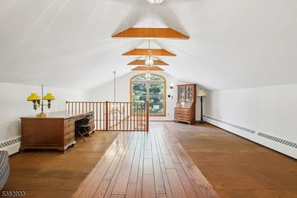 a room with pool table and wooden floor