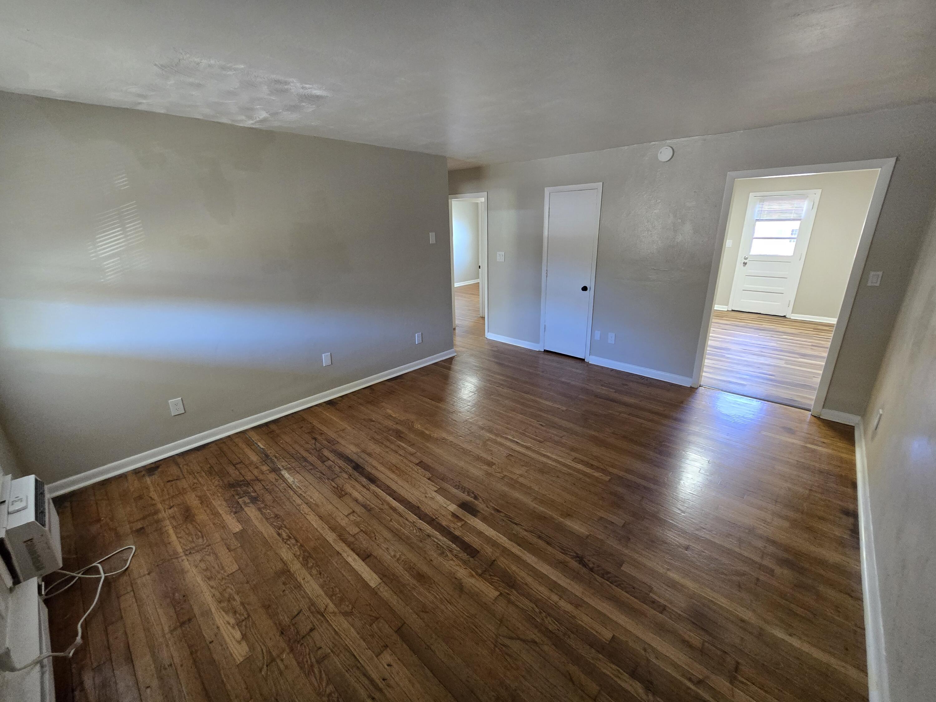 1301 Burks Street Southwest, Unit 204 Roanoke, VA 24015 - Photo 2 of 7 wooden floor in an empty room with a window