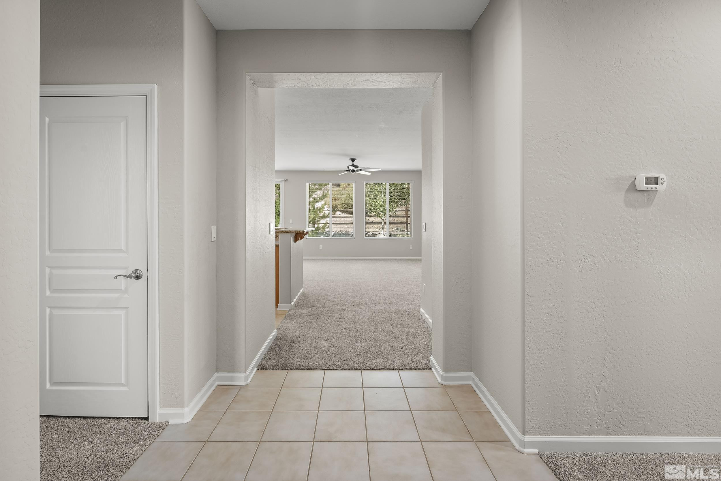 9195 Heritage Ridge Court Reno, NV 89523 - Photo 3 of 30 a view of a hallway view with wooden floor and a bathroom sink