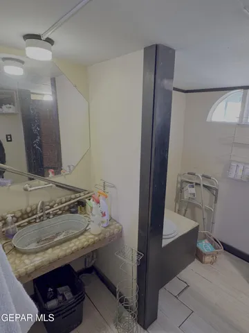 a white toilet sitting next to a shower