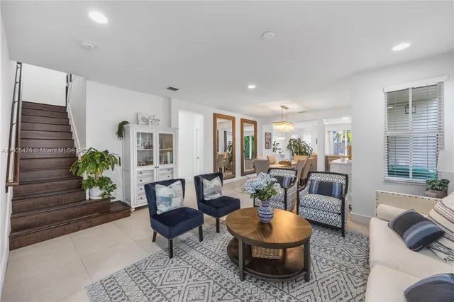a living room with furniture and kitchen view
