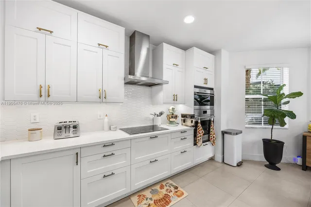 a view of a workspace with furniture and a bookshelf