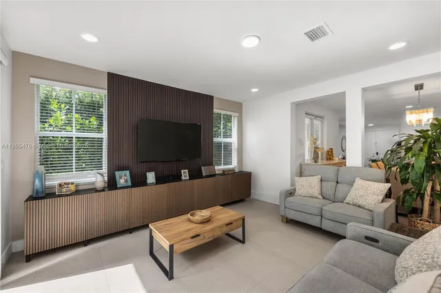 a living room with furniture and flat screen tv