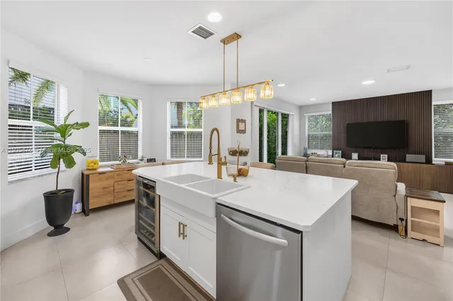 a spacious bedroom with a bed and a flat screen tv