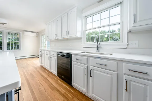 a kitchen with a sink stove and cabinets