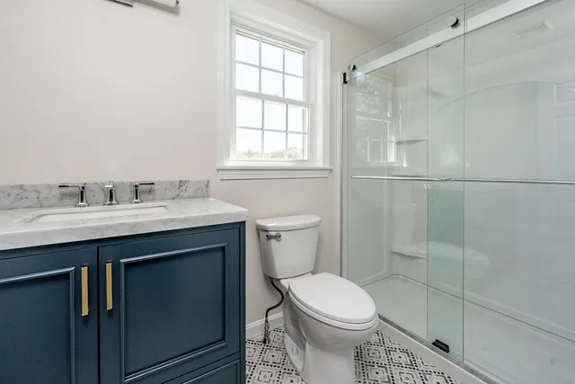 a bathroom with a sink toilet and shower