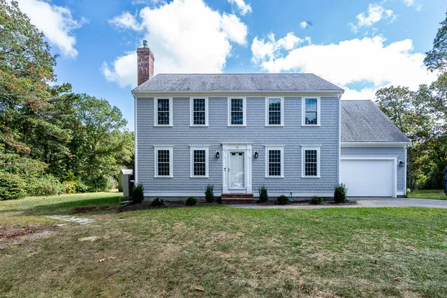 a front view of a house with a yard
