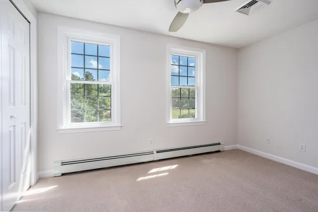 an empty room with a empty space and windows