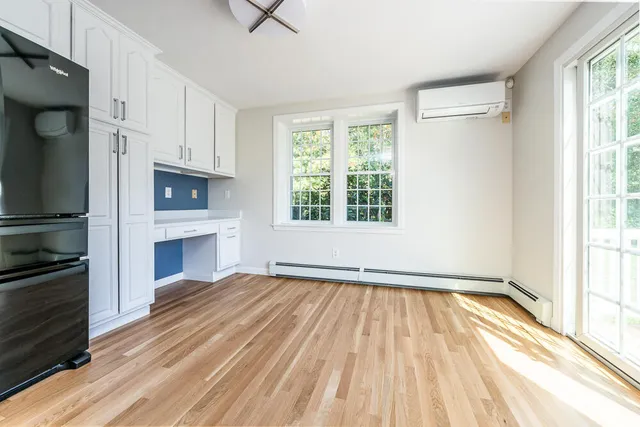 a view of empty room with a fireplace and windows