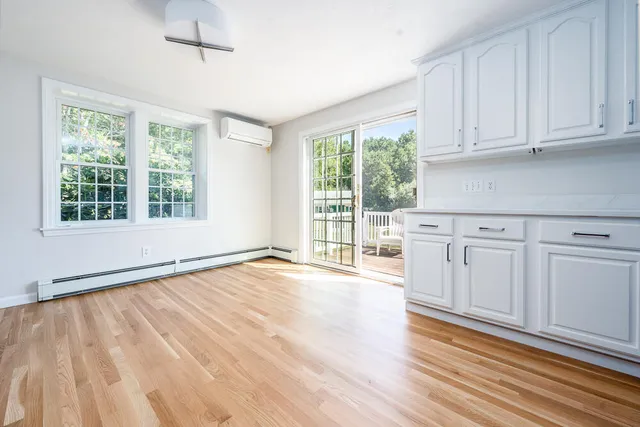 a view of a kitchen with wooden floor and cabinets