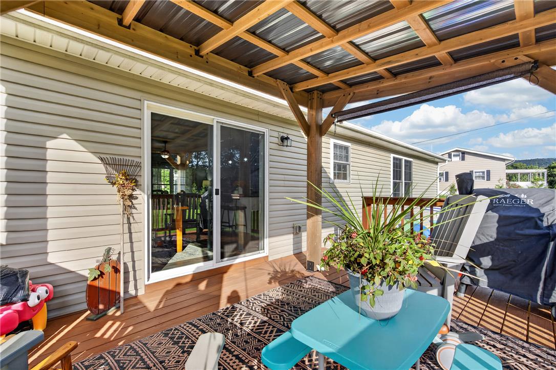 74 Kepners Road New Ringgold, PA 17960 - Photo 23 of 79 A spacious wooden deck features a substantial overhead cover and sliding glass doors.
